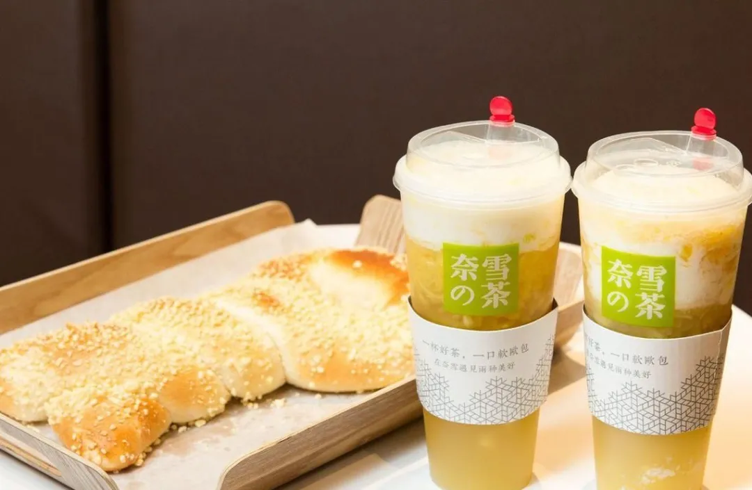 奈雪的茶两杯茶饮搭配托盘上的软欧包